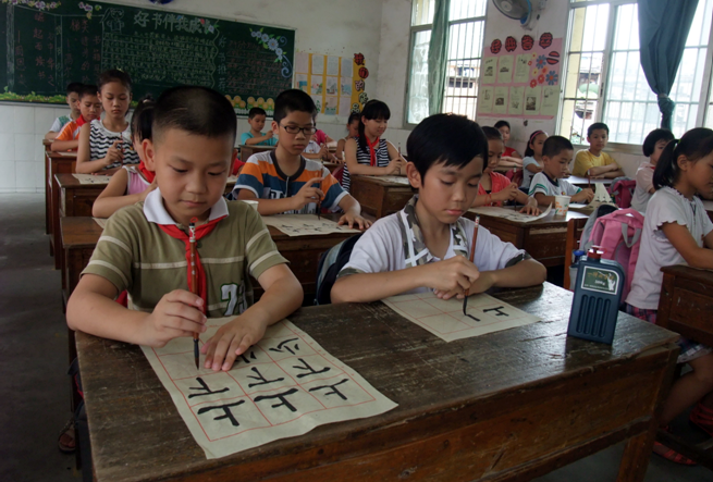 在书法普及活动中,学生们认真书写毛笔字.